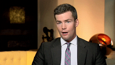 man in suit winked GIF