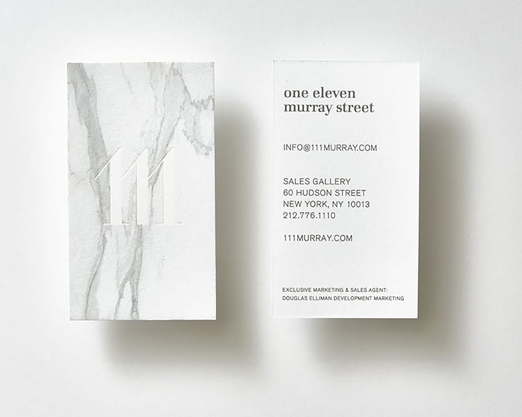 Clean white business card with a minimalist logo and subtle marble design elements