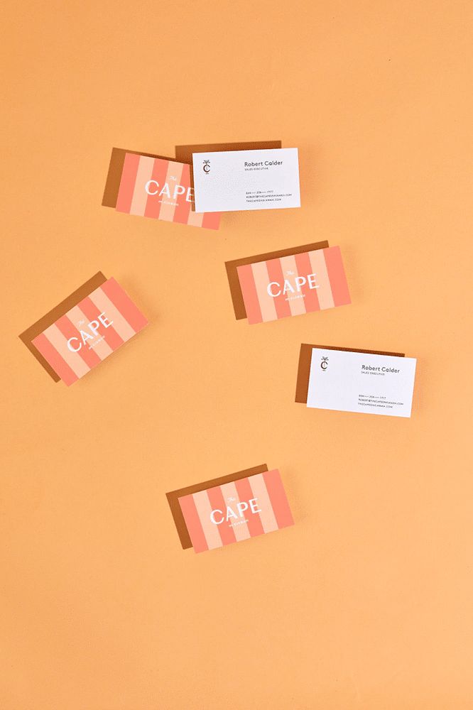 Citrus-colored business card with playful sherbet stripes evoking a beachside vibe