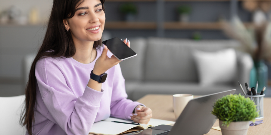 a lady holding a phone while talking