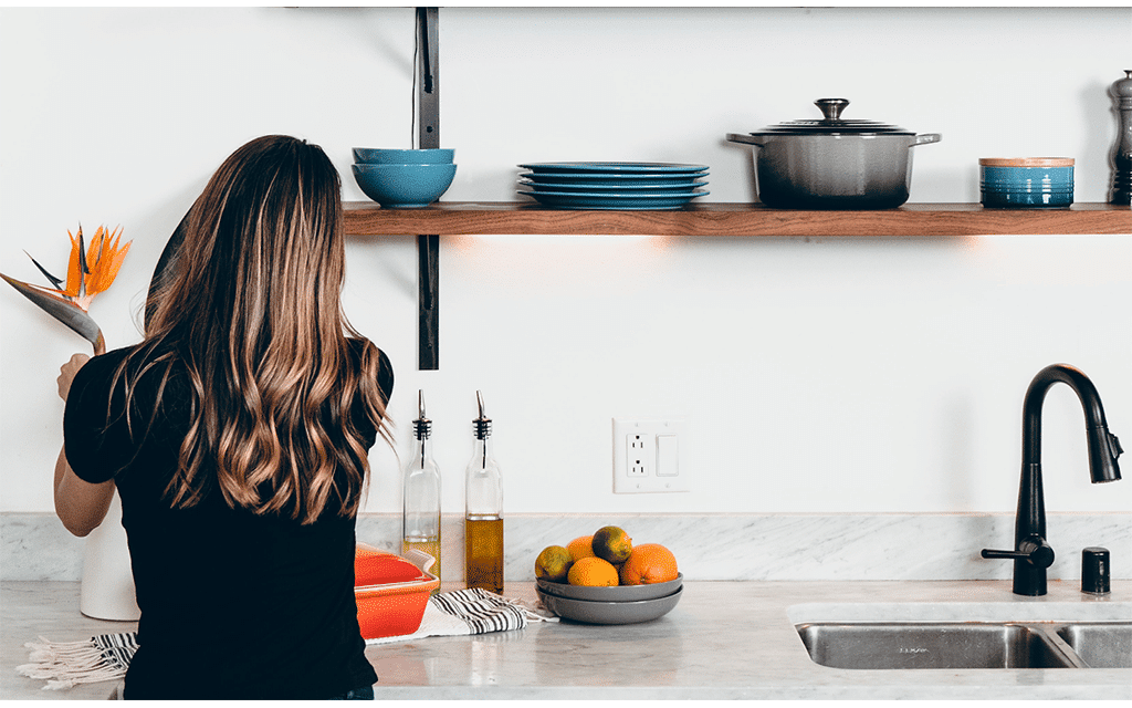 woman arranging flowers in preparation for an open house