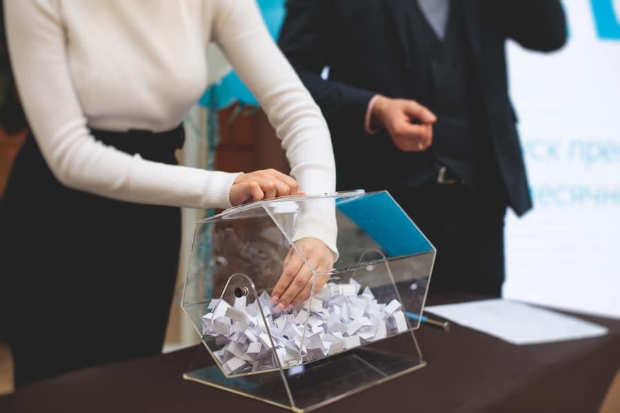 woman drawing out of a raffle container