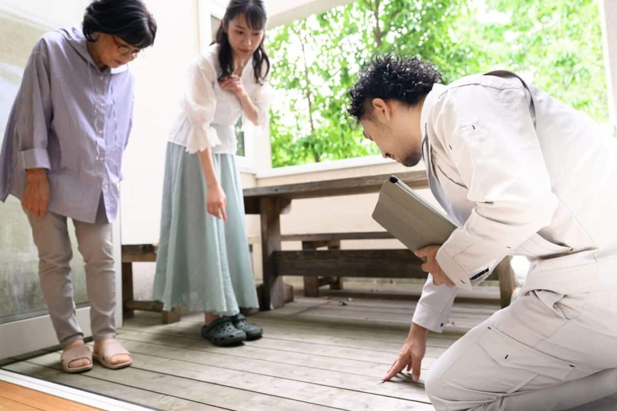 Inspection looking at a wood deck.