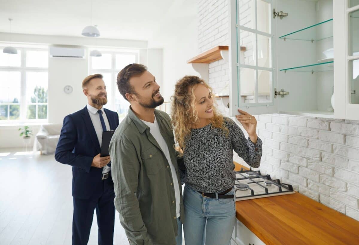 Real estate agent assisting a couple at a property showing