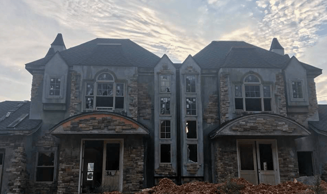 Two McMansions sitting next to each other, both in ruins and abandoned.
