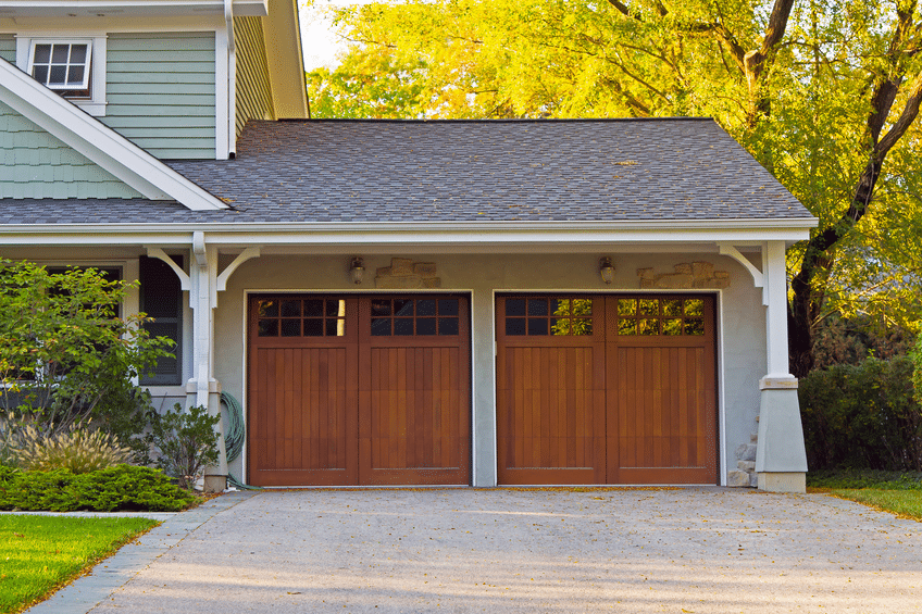 A closed garage with two wooden doors