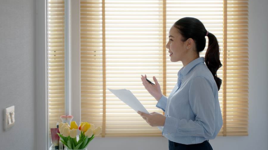 A picture of a woman practicing her real estate elevator pitch