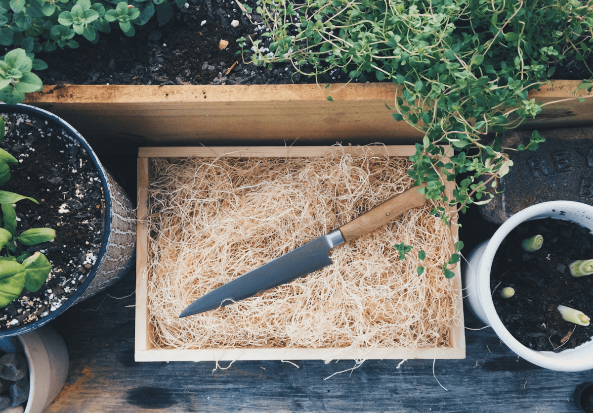 A knife on a brown wooden tray