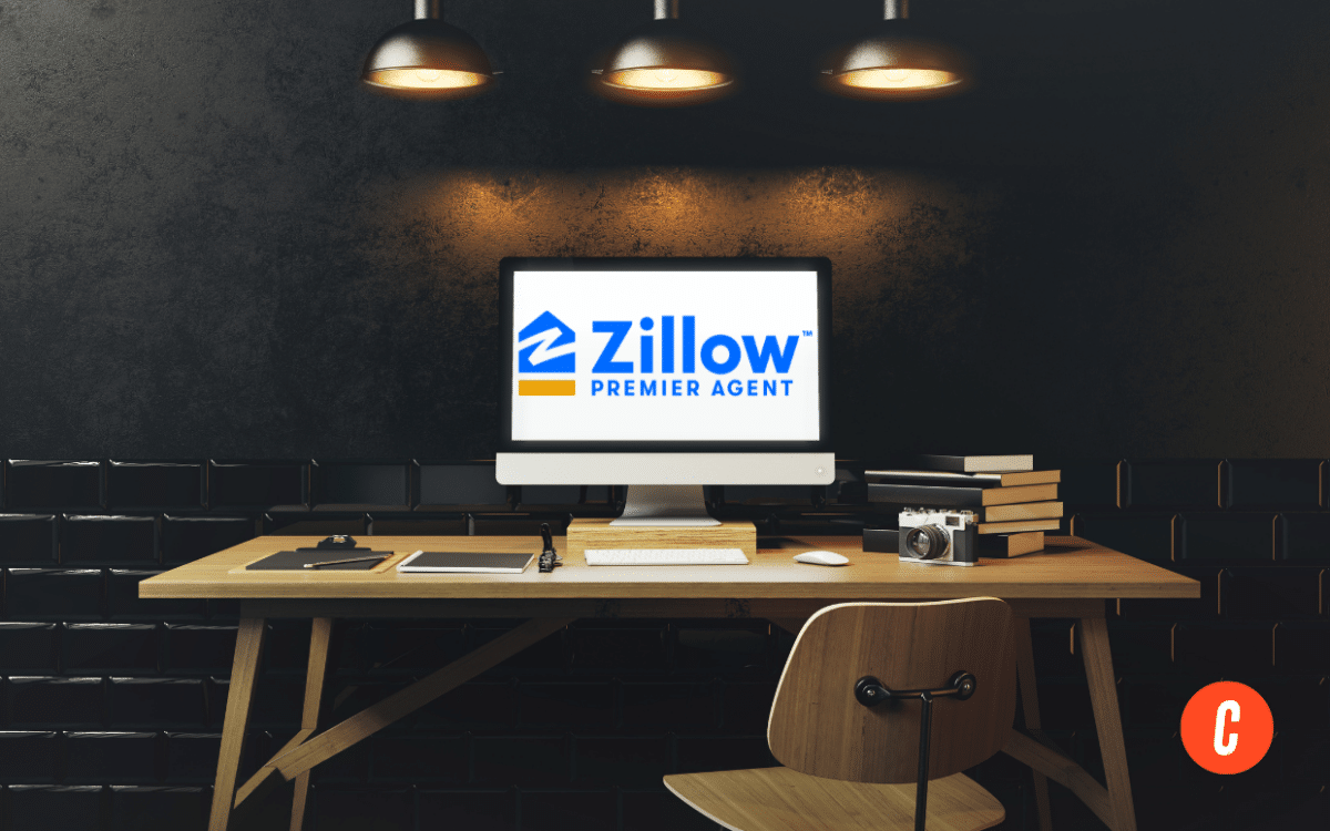 Work desk and computer screen with the Zillow Premier Agent logo