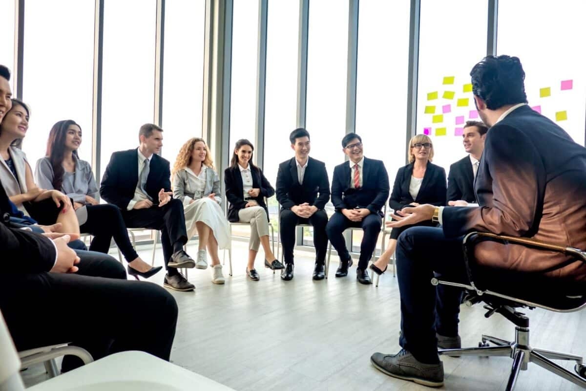 People sitting a circle conversing.