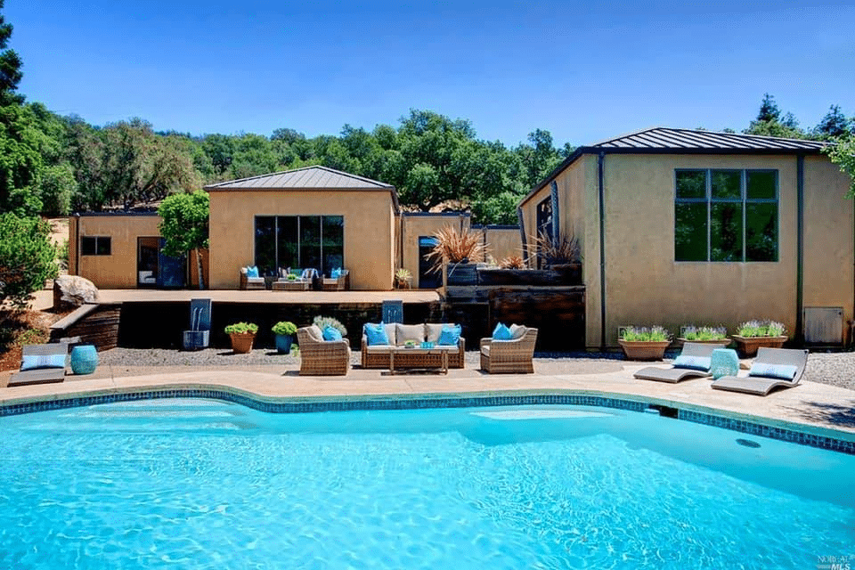 Backyard pool with furniture on patio