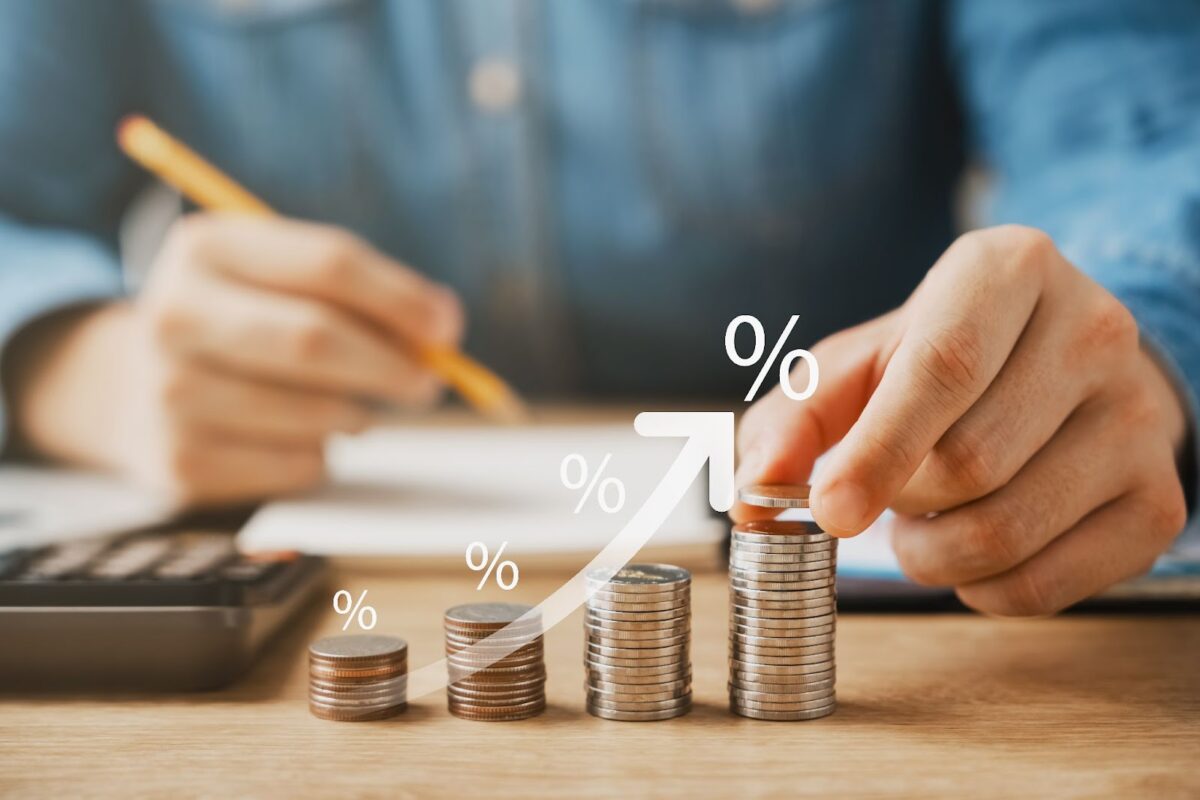 Stacks of coins showing percentages of upward growth.