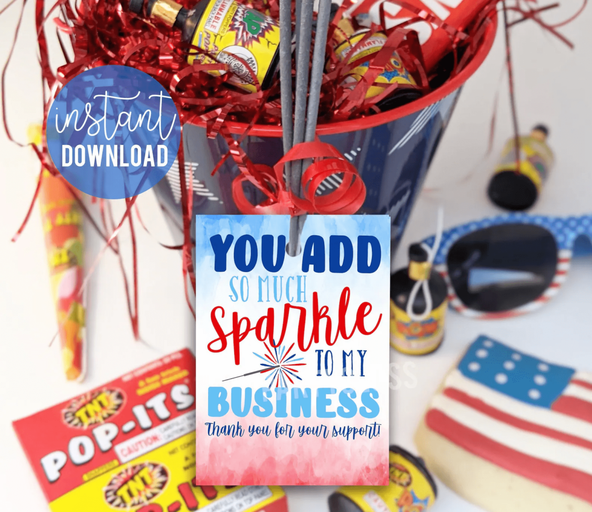 A bucket full of Fourth of July party favors with an example of a real estate agent thank you card attached to it.