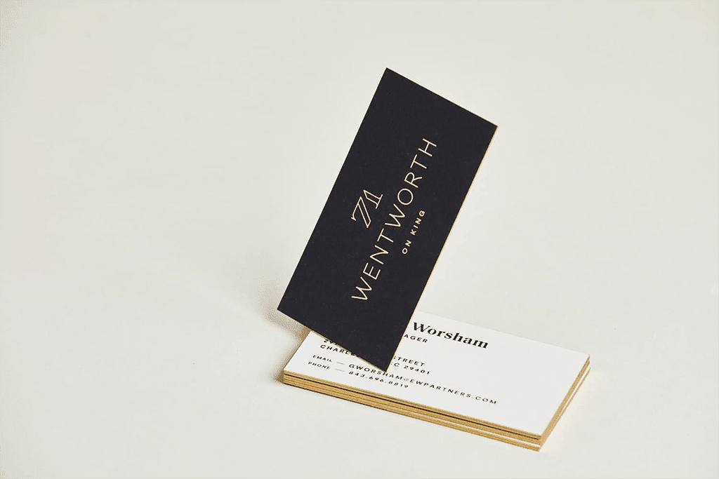 Black business card with a centered logo and colored edges