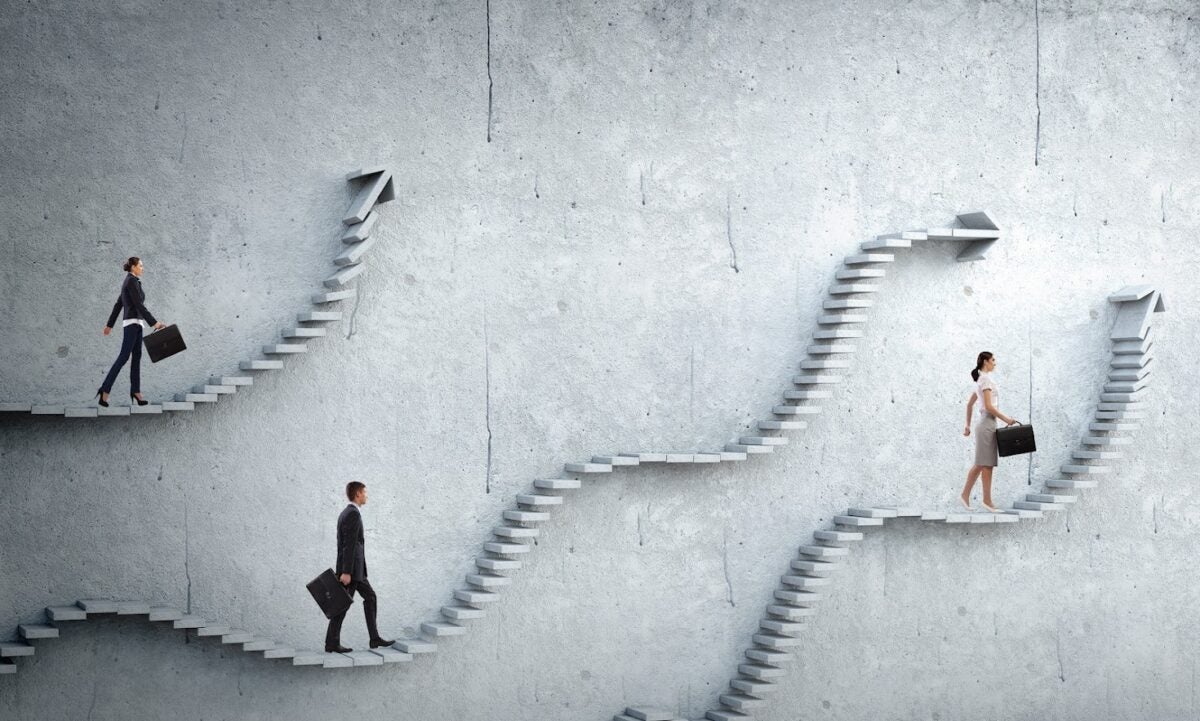 Three real estate agents walking along steps with arrows pointing them in the right direction.