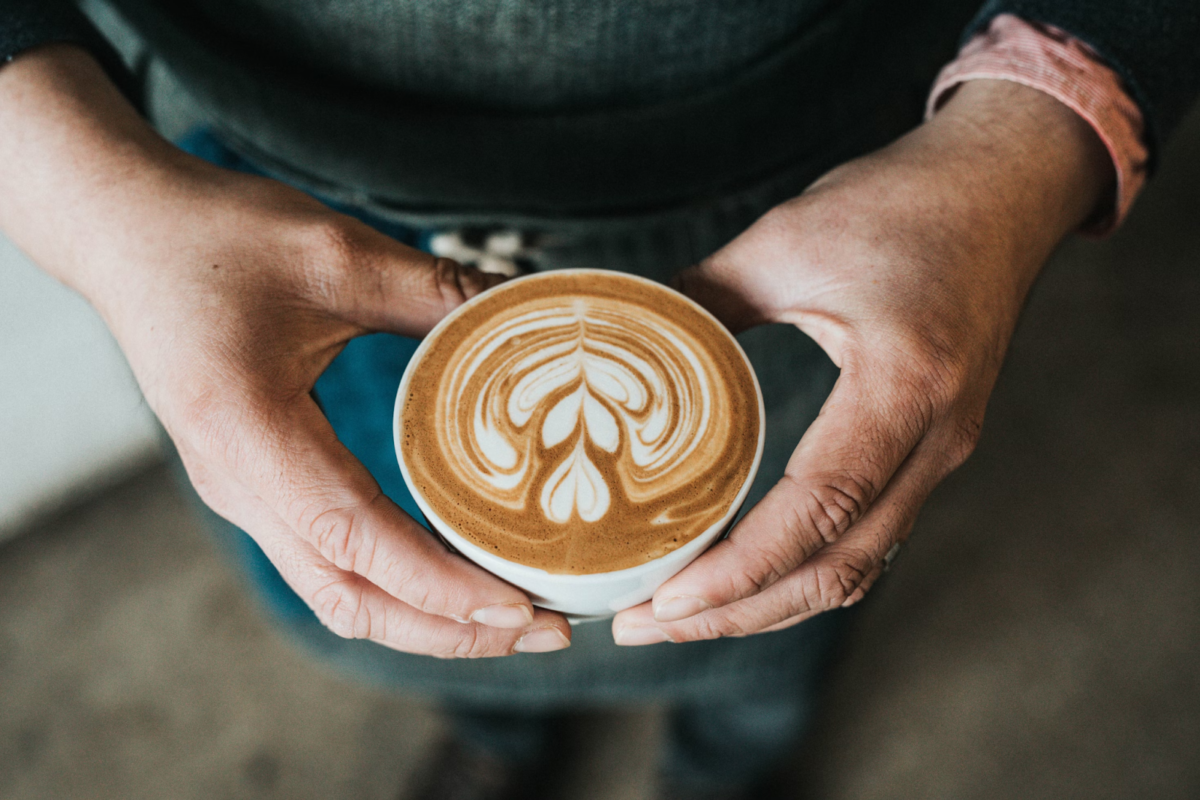 Hands holding a cup of coffee