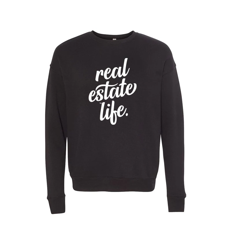 A black crew neck sweater with "real estate life" printed on it