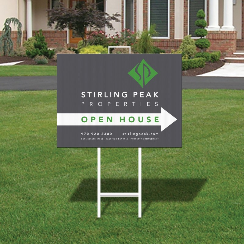 Real estate open house sign with a rider perfectly placed outside a property