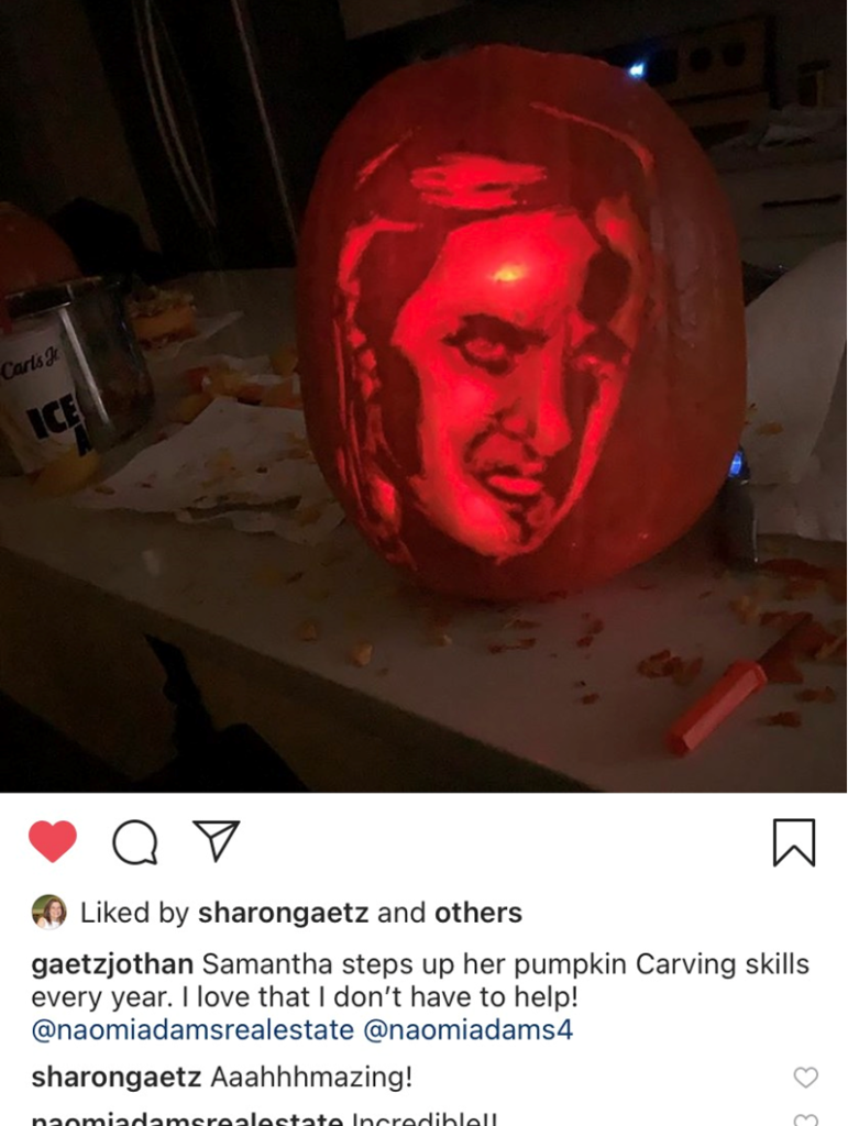 An Instagram post of a carved pumpkin on a table.