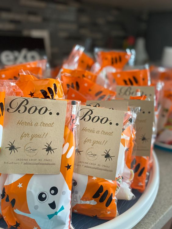 Candy bags with ghosts and a note with contact information.