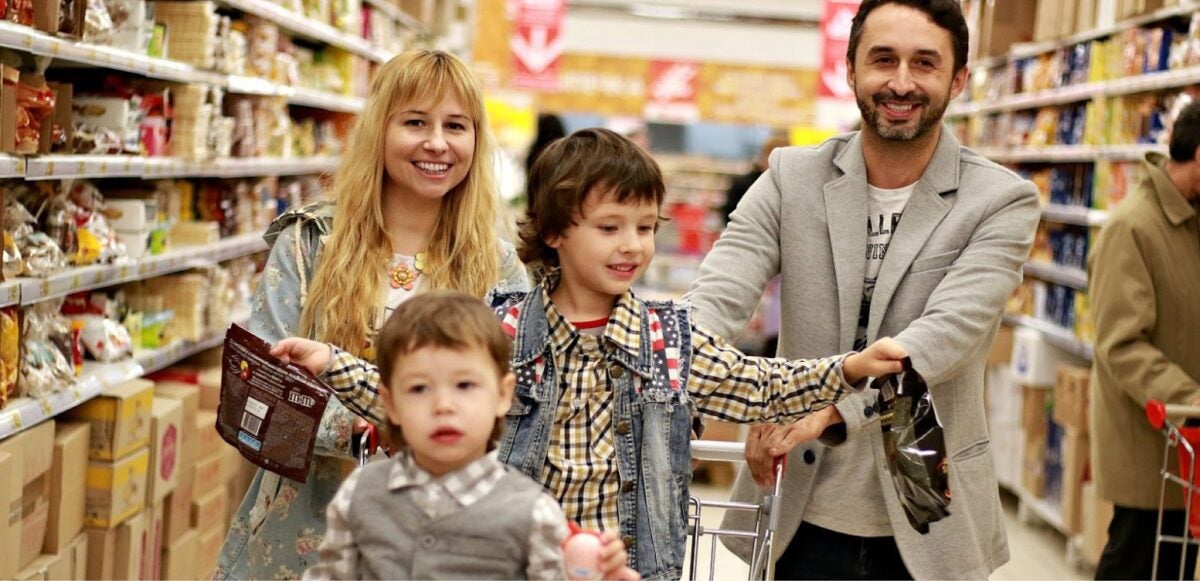 A family of four shopping for Thanksgiving at a store.