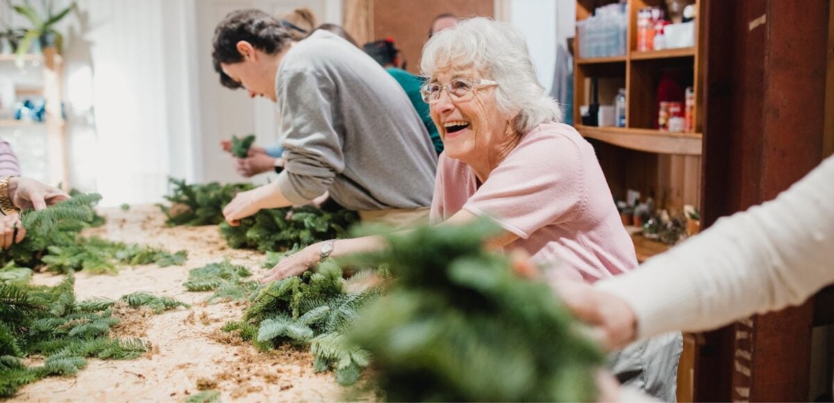 People making holiday wreaths.