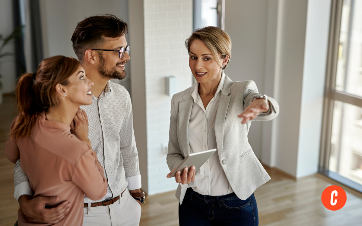Real estate agent showing a property to a couple