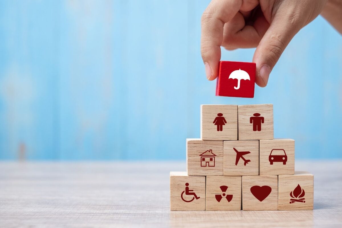 Blocks stacked with icons representing the concept of insurance.