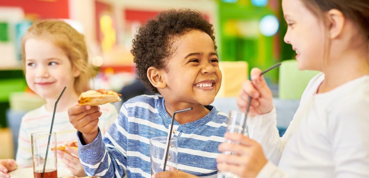 Kids enjoying food and drinks.