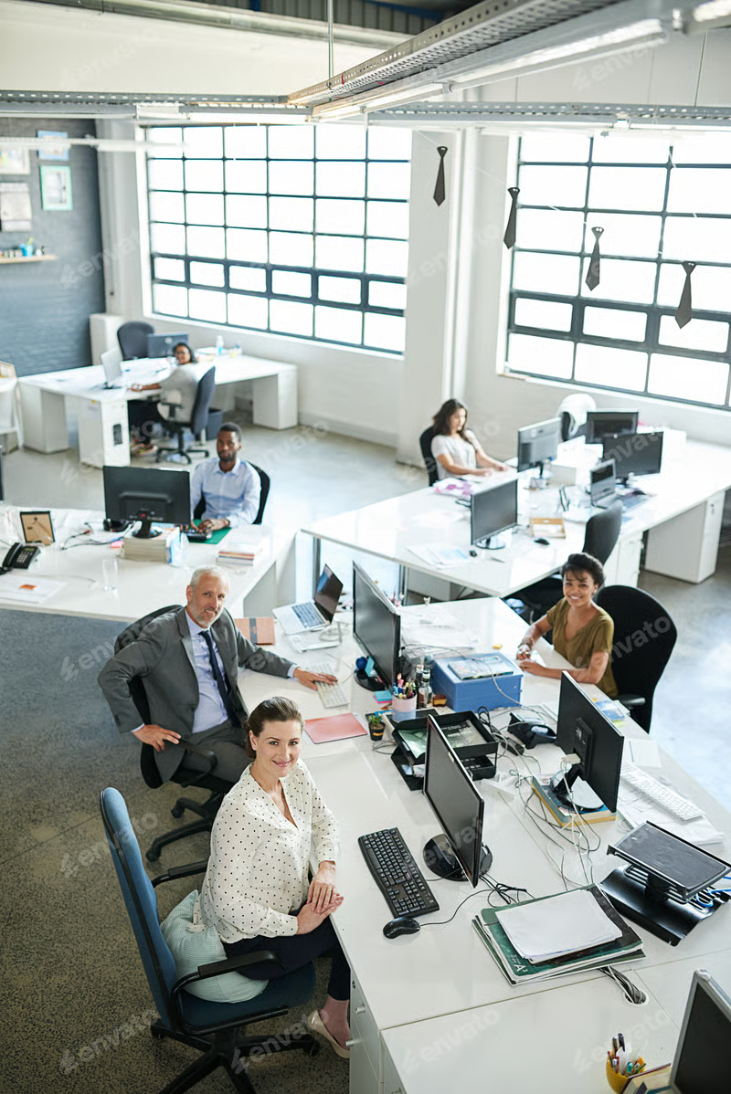 A a group of coworkers sitting at their workstations in an office