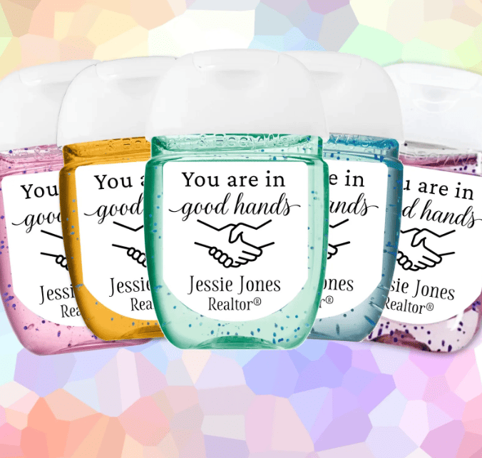 Green hand sanitizer labeled "You are in good hands" with handshake graphic and realtor's name.