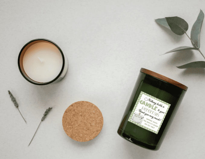 Green candle with tag says "Nothing holds a candle to your referrals" and includes contact info.