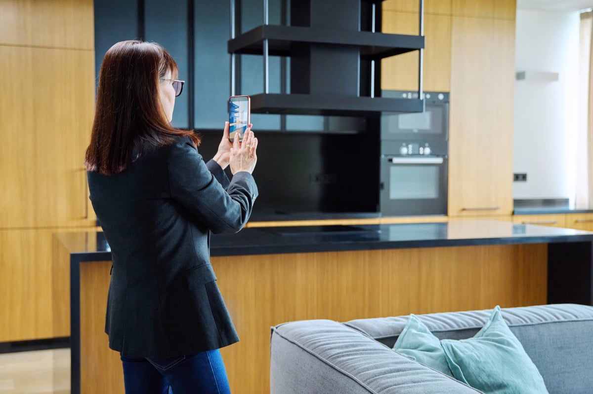 Real estate agent recording a video of a furnished apartment