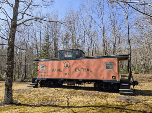The exterior of a train caboose converted into a home.