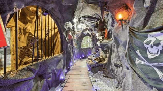 Small walk way with pirate themed facade on both sides.