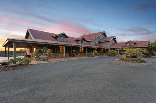 Exterior of the home in front of a beautiful sunset.