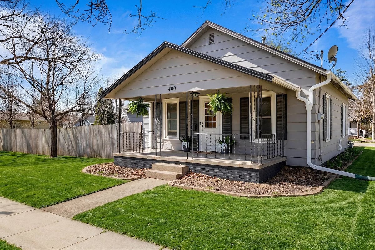 A grey home with a front porch.