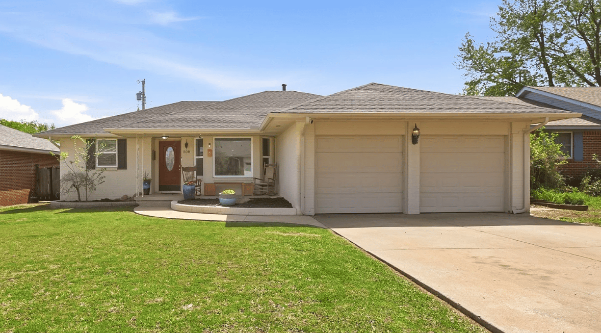 A white ranch home with a double garage.