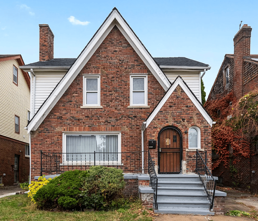 A brick home with white trim.