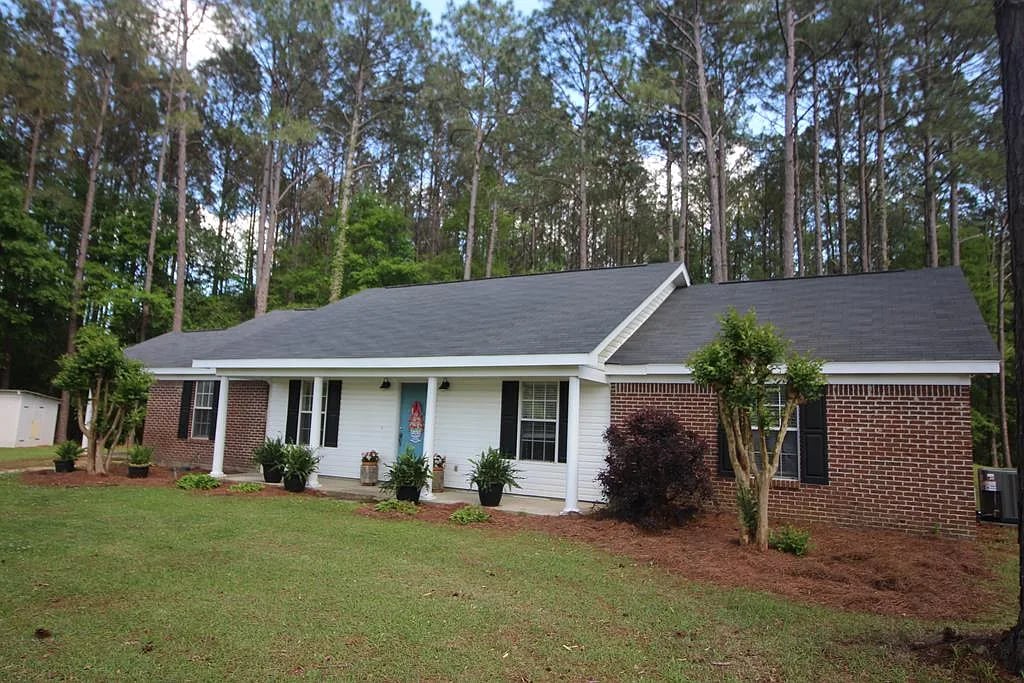 A ranch with brick and white siding exterior.