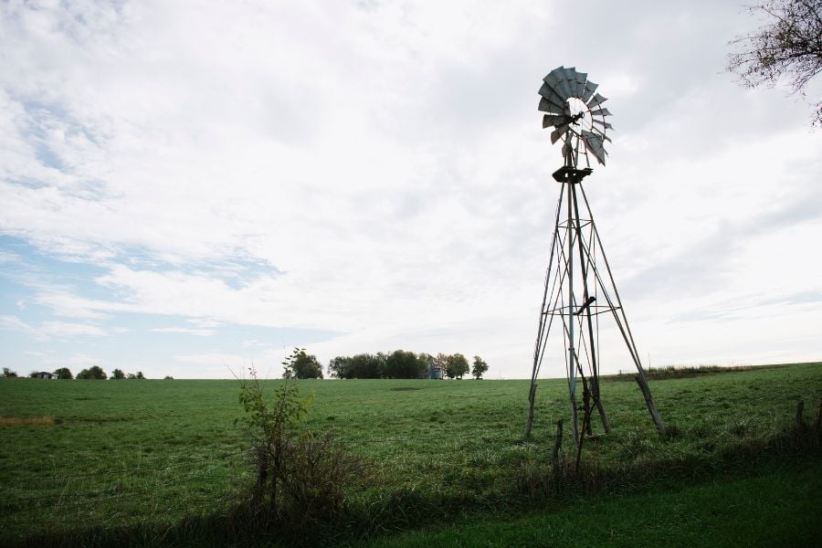 Windmill on field hillside, Missouri, USA